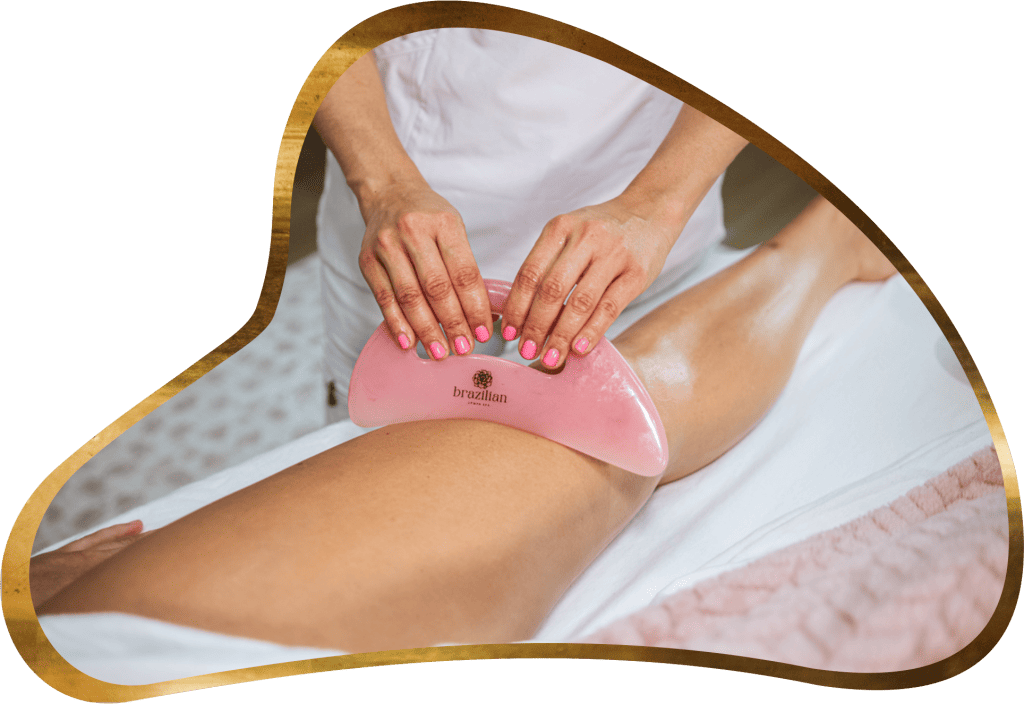 A woman is waxing her legs with a pink paddle.